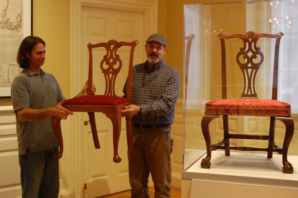 Matt Wajda (left), a 2001 graduate of the NBSS program, holds one of the side chairs he made for the Council Chamber project next to a chair from the collection. (Photo courtesy of the Bostonian Society)